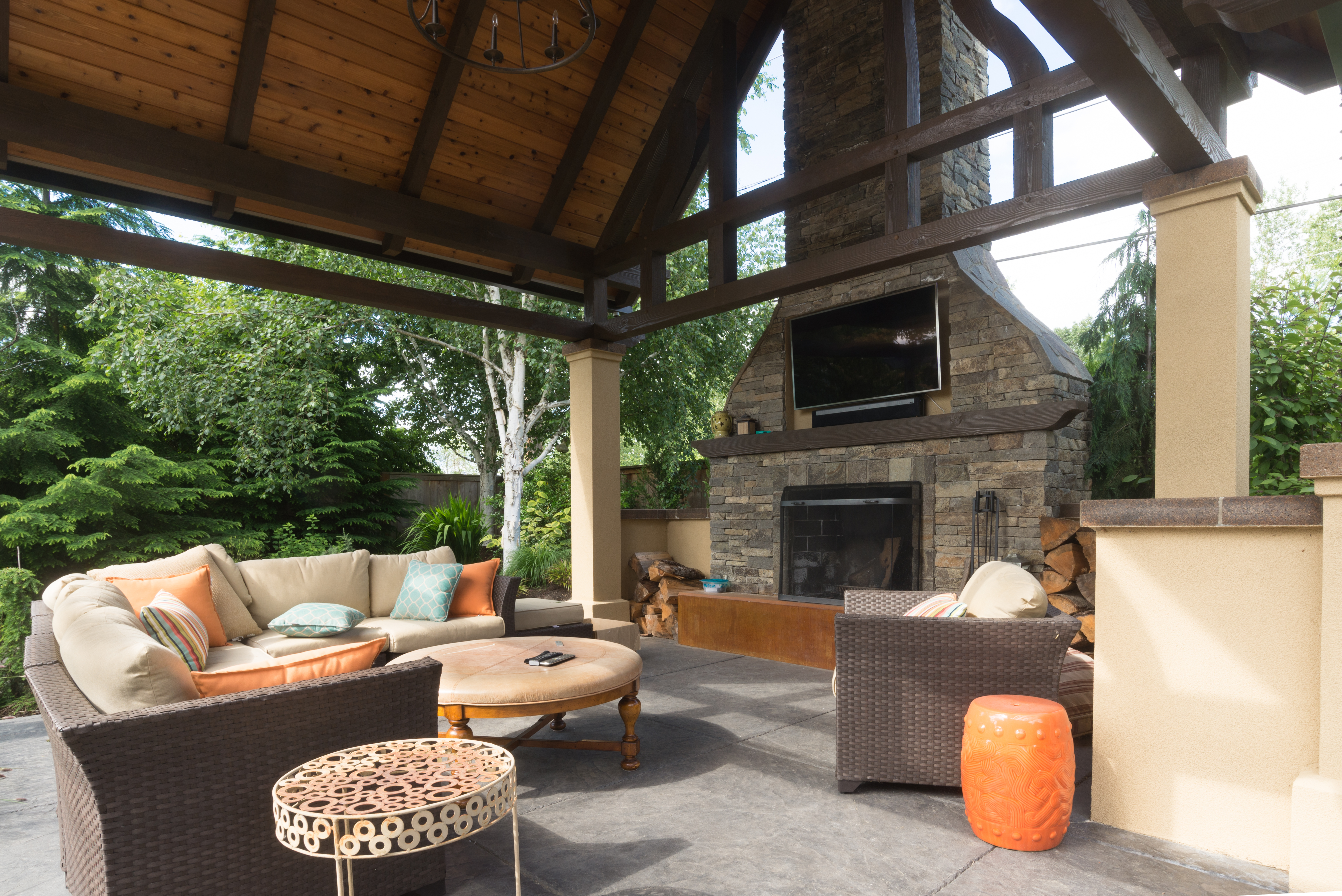 upscale outdoor terrace/room with comfortable furniture and big fireplace