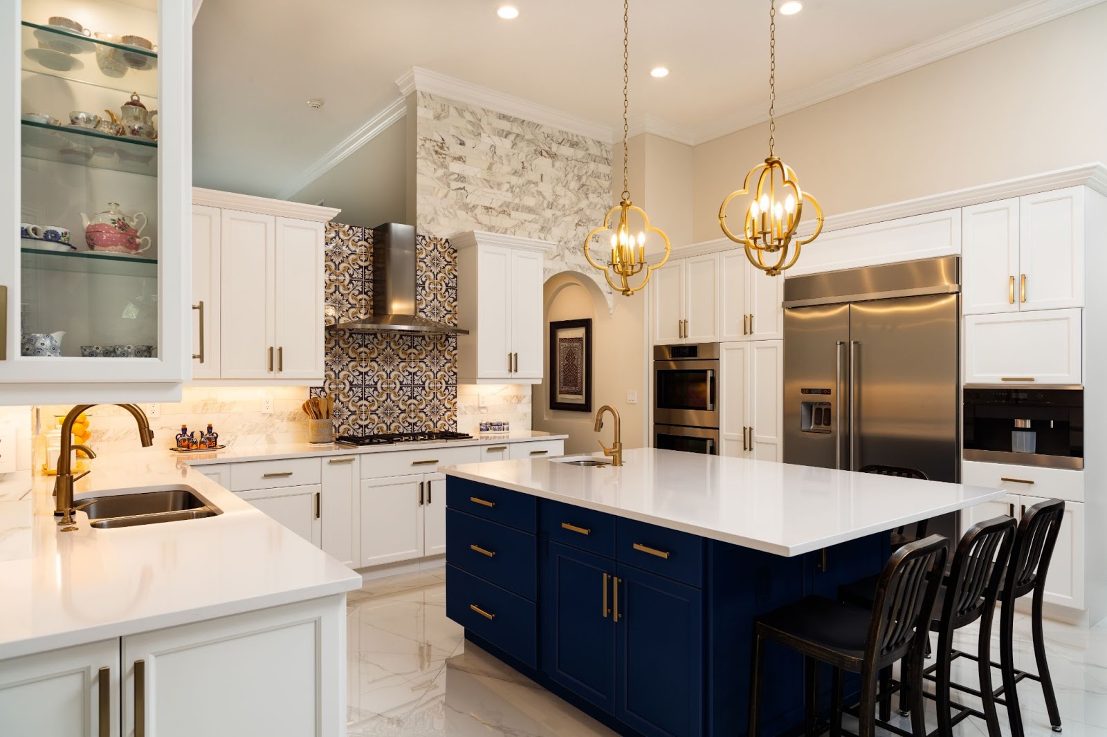 luxurious kitchen with black and white cabinets, an island, and gold hardware