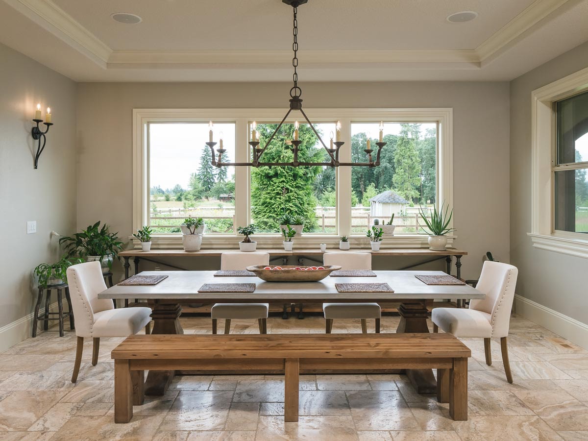 luxurious ranch style dining room with white chair and wooden table