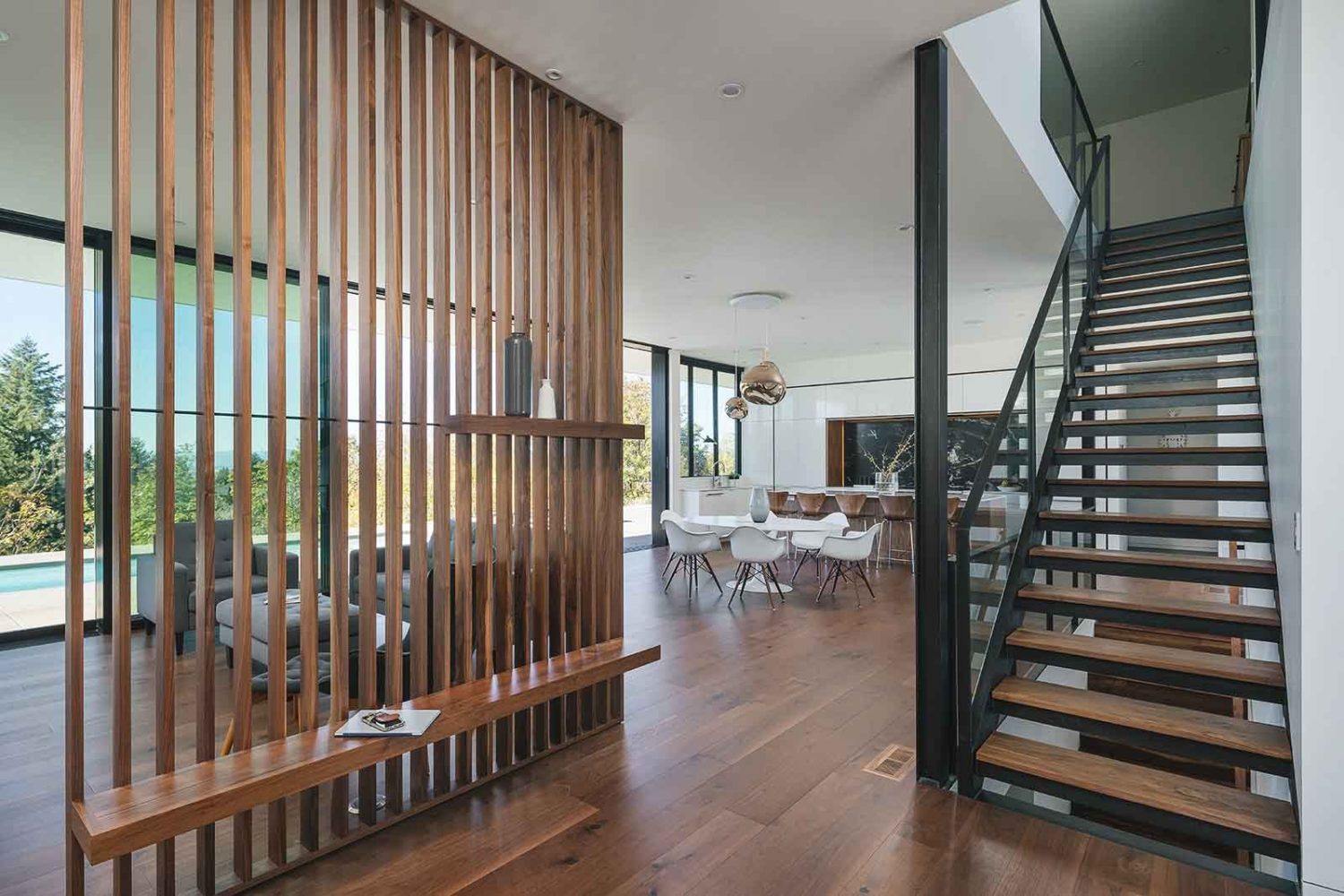 Modern entryway with wooden room divider and bench designed by architect Paul McKean